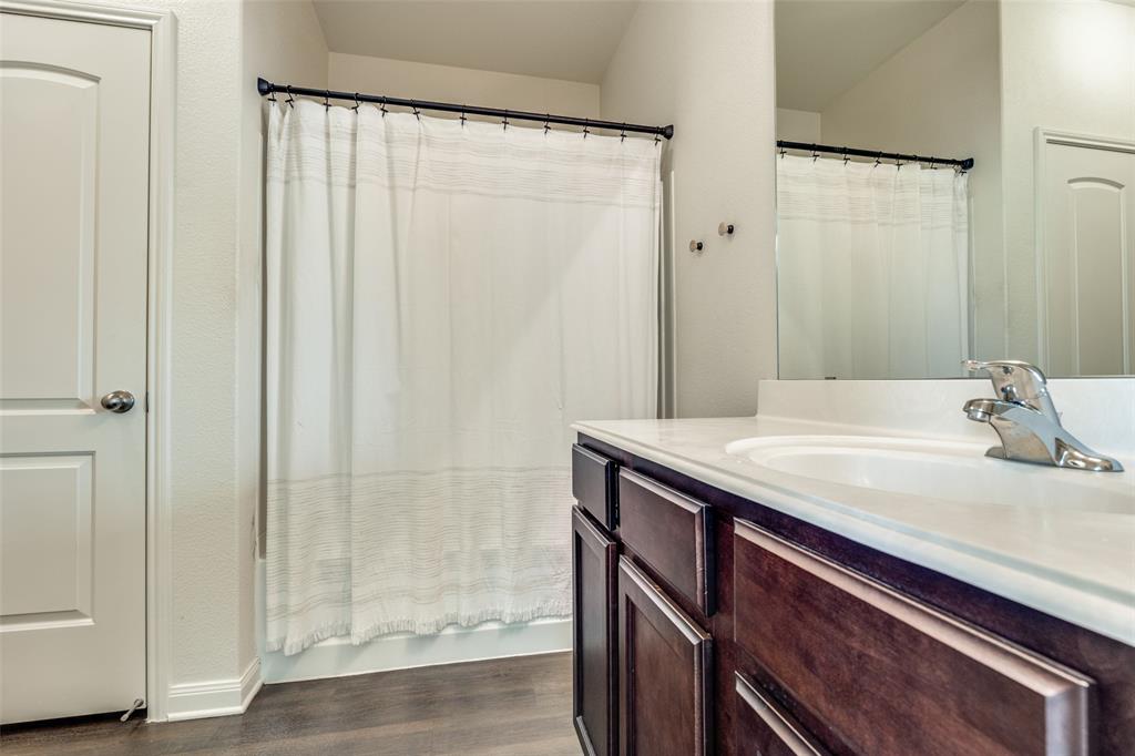 14240 Chaps Drive Dallas, TX 75253 - Photo 15 of 25 a bathroom with a granite countertop sink and shower