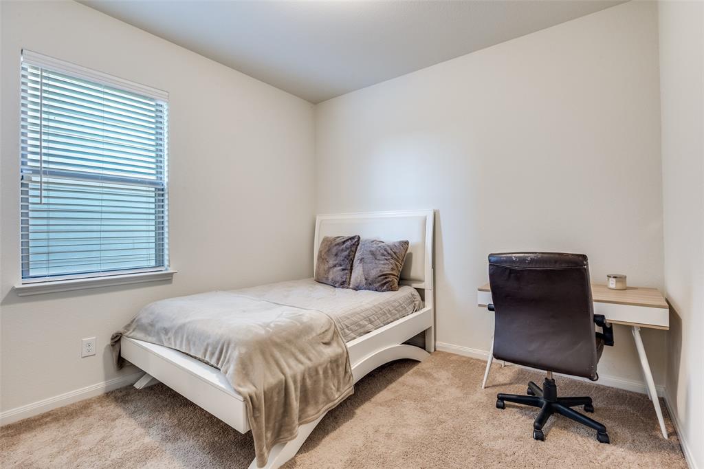 14240 Chaps Drive Dallas, TX 75253 - Photo 17 of 25 a bedroom with a bed chair and a window