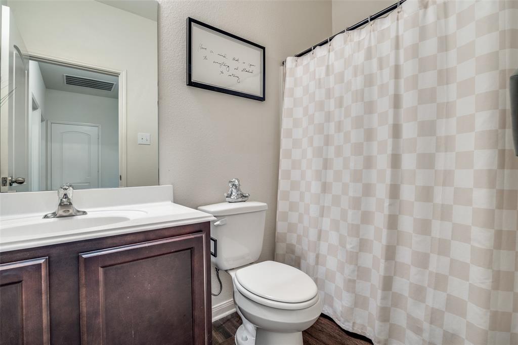 14240 Chaps Drive Dallas, TX 75253 - Photo 18 of 25 a bathroom with a sink and a toilet