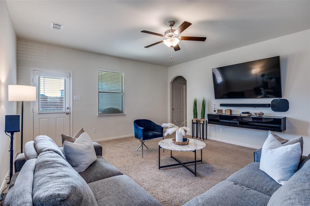 14240 Chaps Drive Dallas, TX 75253 - Photo 2 of 25 a living room with furniture and a flat screen tv