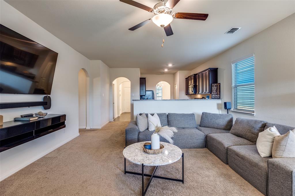 14240 Chaps Drive Dallas, TX 75253 - Photo 4 of 25 a living room with furniture and a flat screen tv
