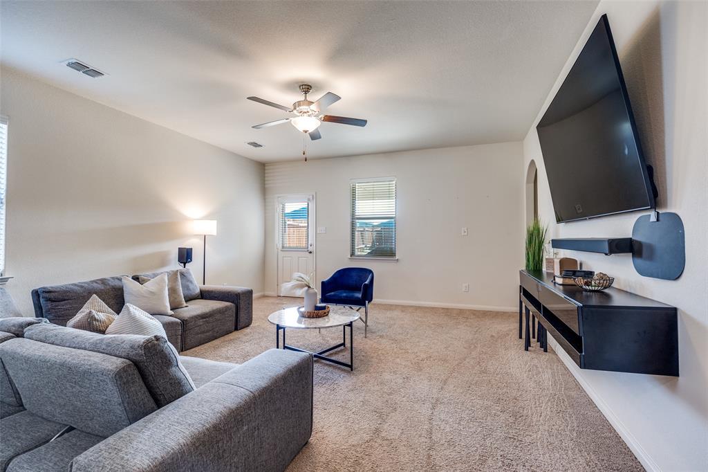 14240 Chaps Drive Dallas, TX 75253 - Photo 6 of 25 a living room with furniture ceiling fan and a rug
