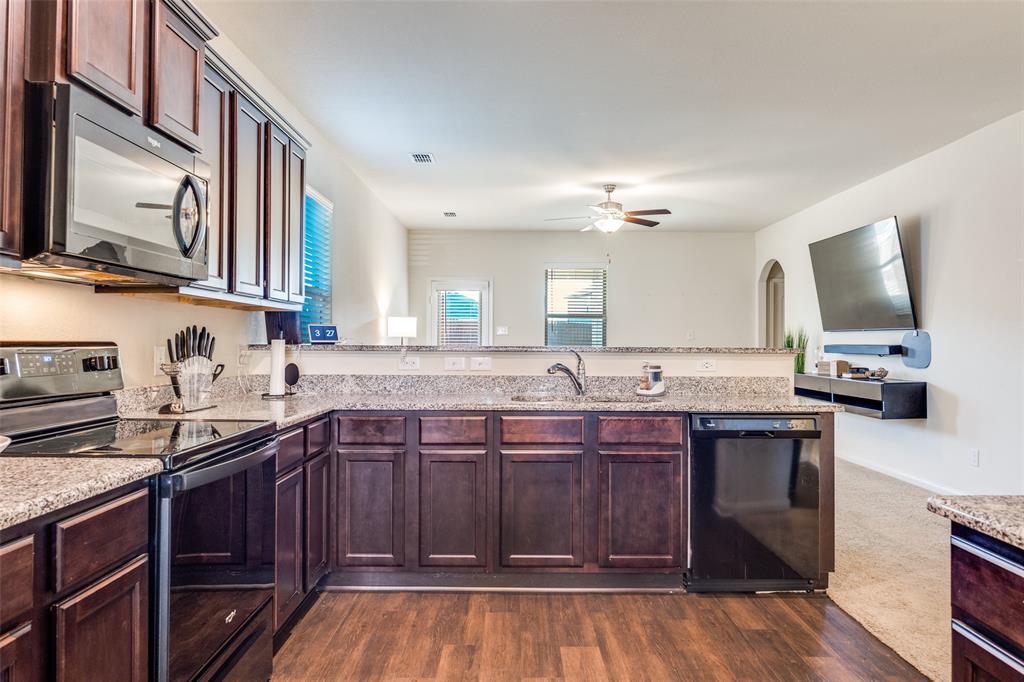 14240 Chaps Drive Dallas, TX 75253 - Photo 8 of 25 a kitchen with a sink cabinets and wooden floor