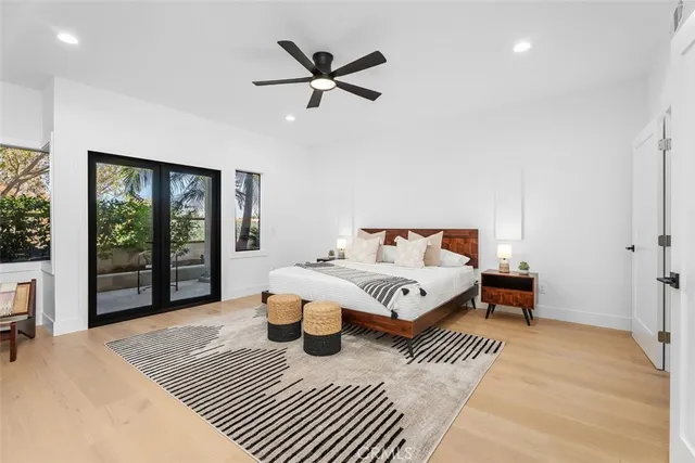 a bedroom with a bed and a large window