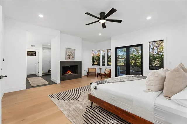 a bedroom with a large bed and a fireplace