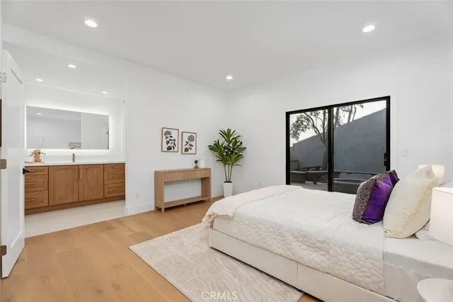 a bedroom with a large bed and a chandelier