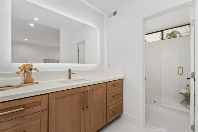 a bathroom with a sink and mirror