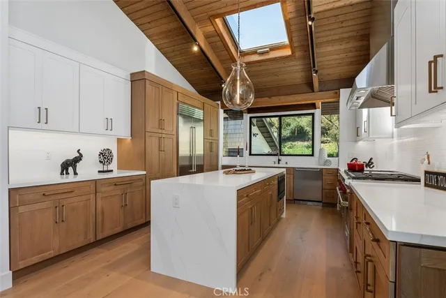 a kitchen with a stove a sink and a refrigerator