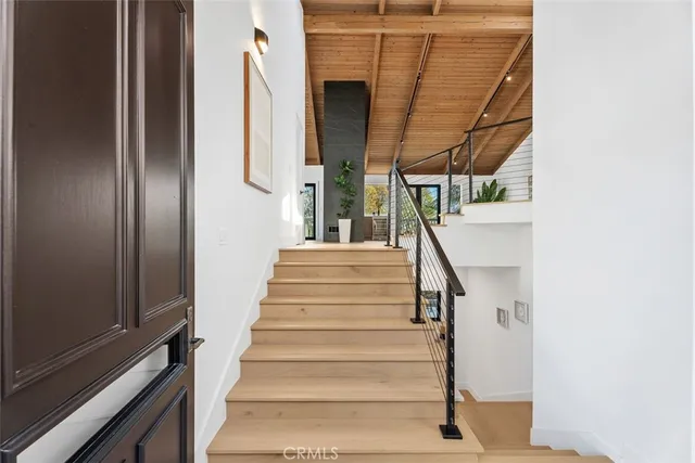 a view of staircase with white walls and railing