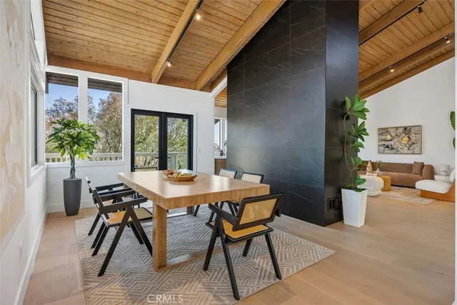 a view of a patio with a table and chairs and potted plants