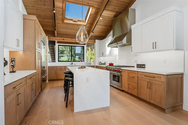 a kitchen with cabinets a sink and appliances
