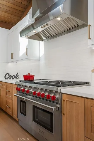 a kitchen with stainless steel appliances a sink and a stove
