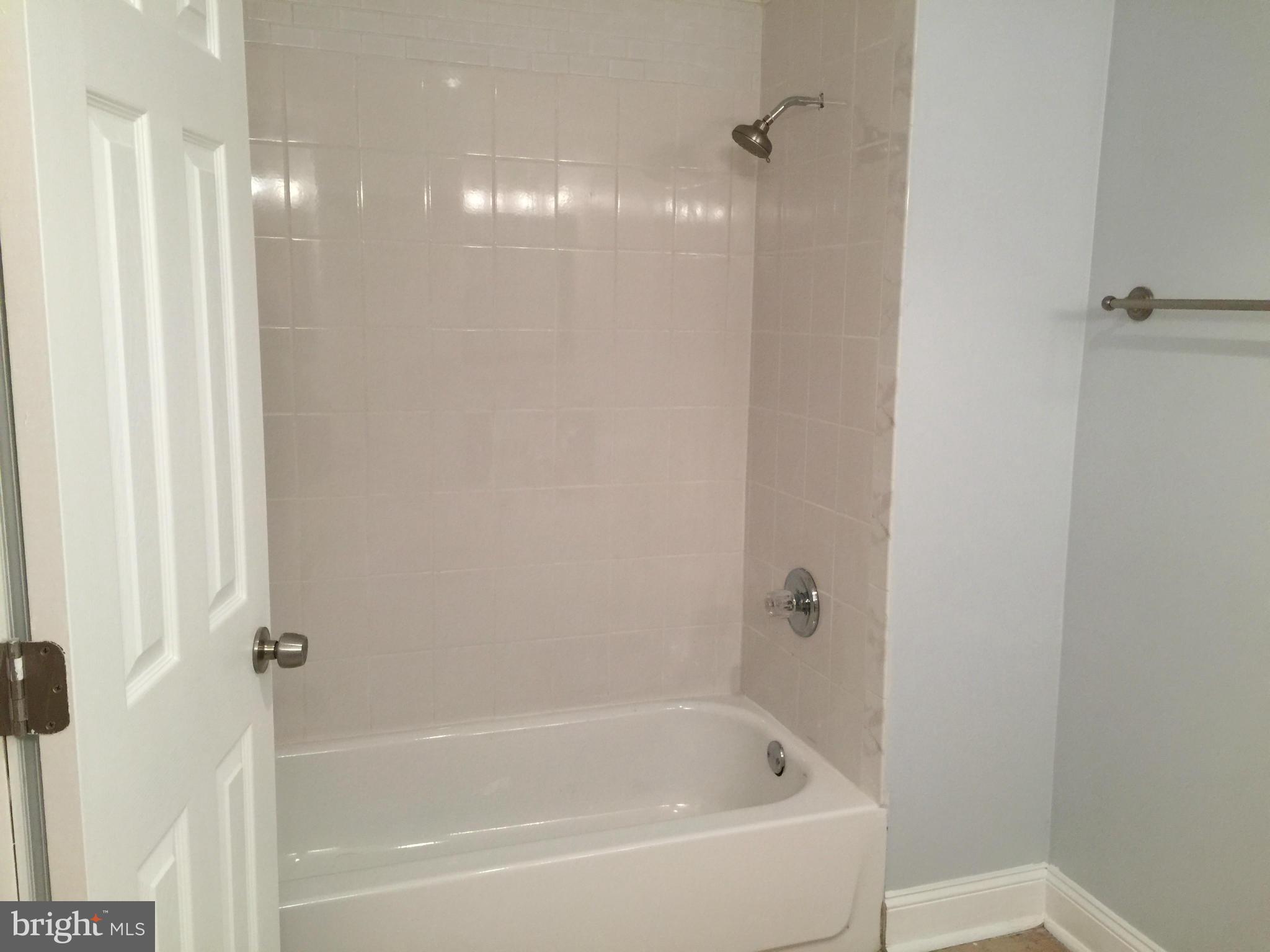 23813 Stringtown Road Clarksburg, MD 20871 - Photo 11 of 12 a white bath tub sitting next to a shower