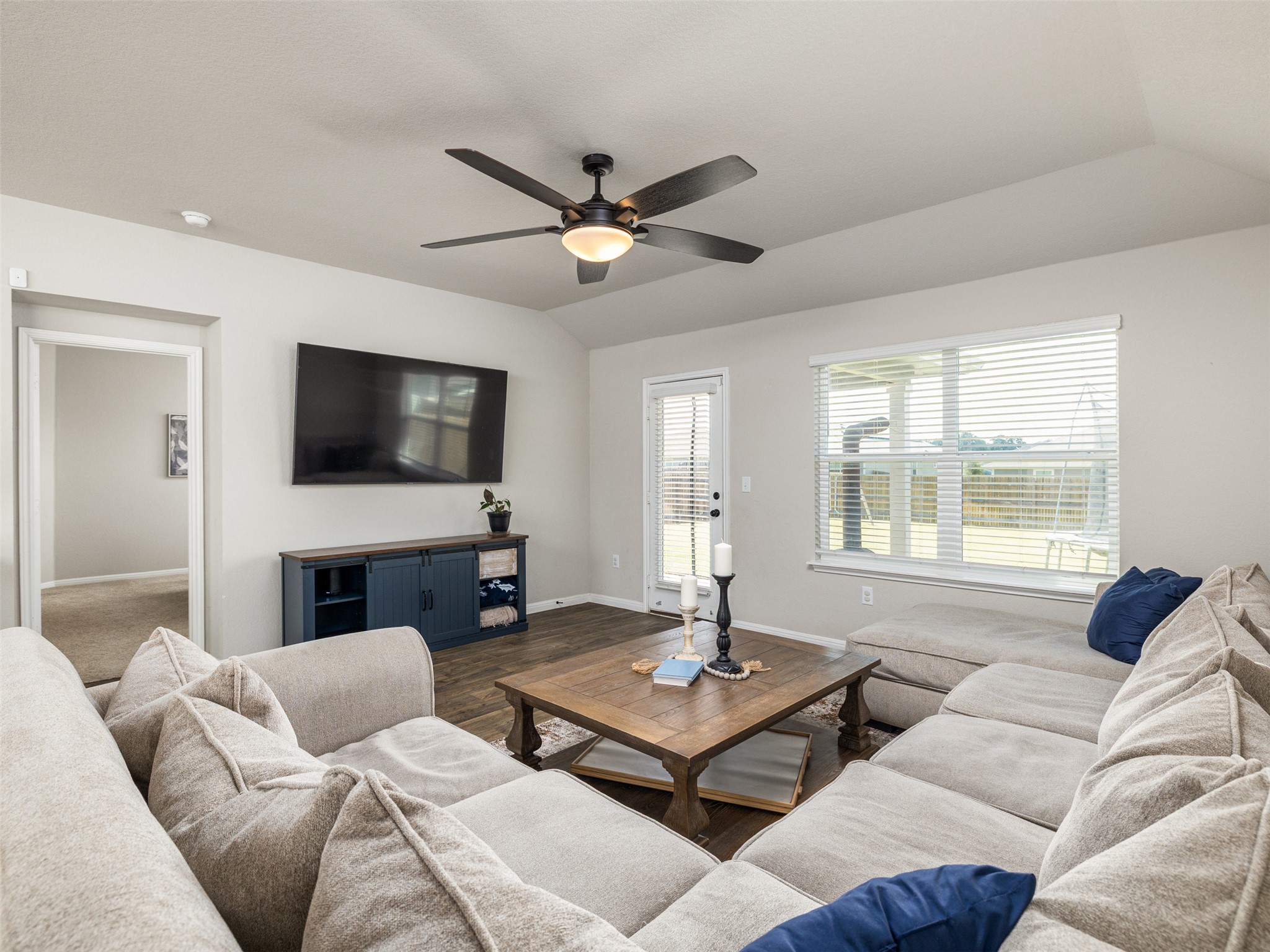 439 Hunter Loop Bertram, TX 78605 - Photo 6 of 23 A comfortable living space boasts a ceiling fan, a large window, and durable flooring.