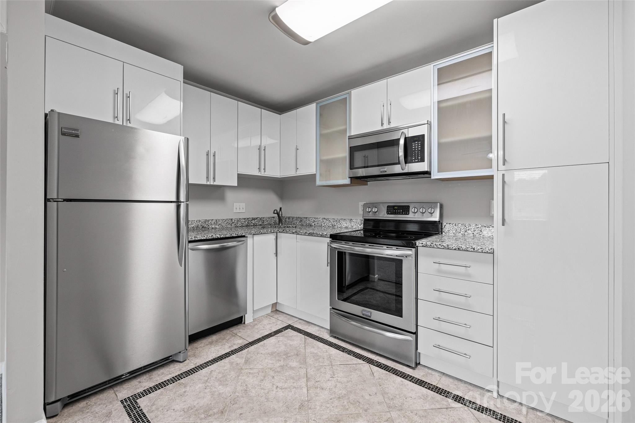 113 Stroupe Road, Unit E Gastonia, NC 28056 - Photo 11 of 33 a kitchen with a refrigerator stove and microwave