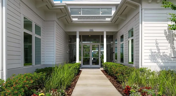 a view of a house with swimming pool and sitting area