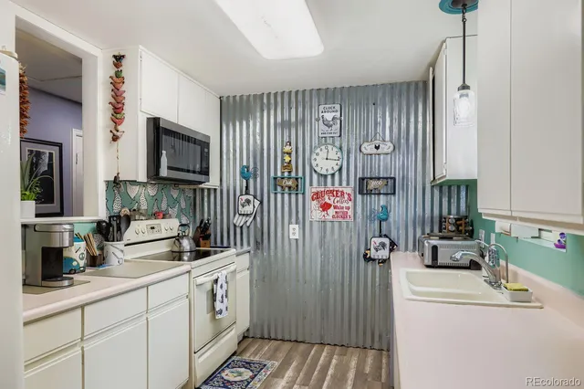 a kitchen with a sink stove and refrigerator