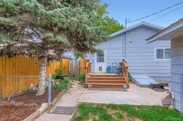 a view of a patio with table and chairs and potted plants
