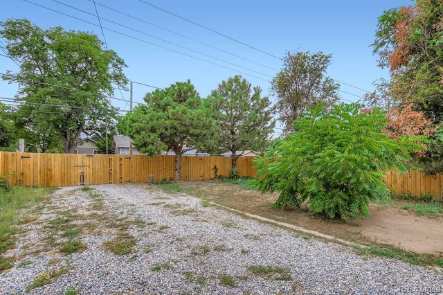 a backyard of a house with plants and outdoor seating