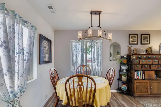 a view of a dining room with furniture window and wooden floor