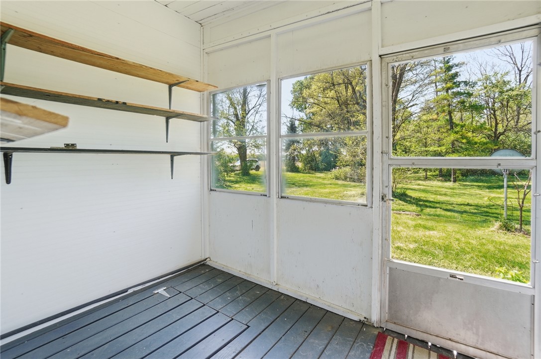 1444 Eagle City Road Springfield, OH 45504 - Photo 27 of 50 Enjoy views of nature from this inviting sunroom, offering a serene escape.