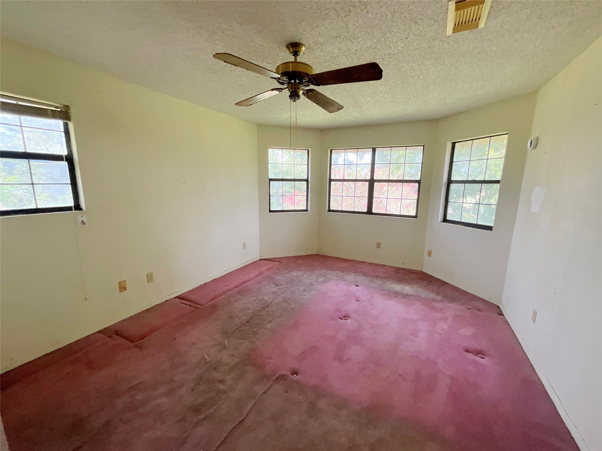 1571 FM 640 Road Wharton, TX 77488 - Photo 12 of 15 an empty room with windows and ceiling fan