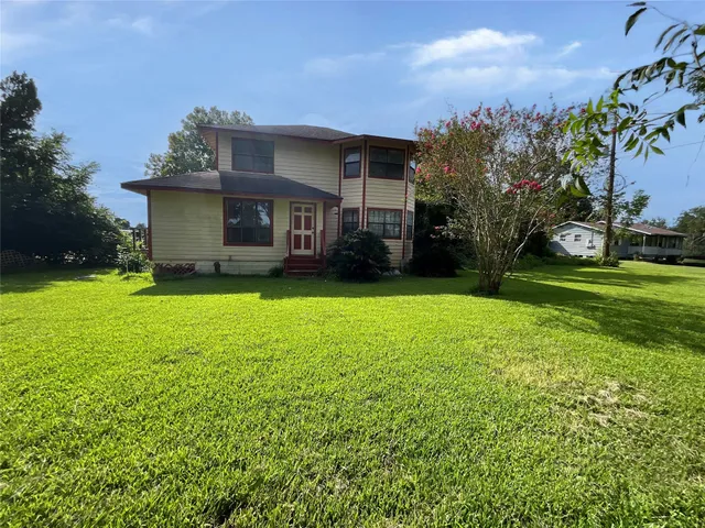 a view of a house with a yard and sitting area