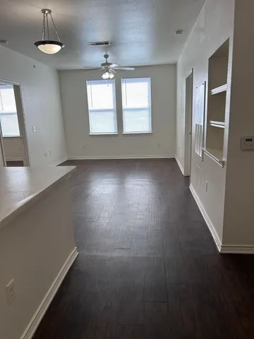 an empty room with windows and entrance