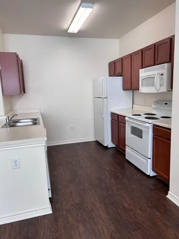 a kitchen with a stove a sink and a refrigerator