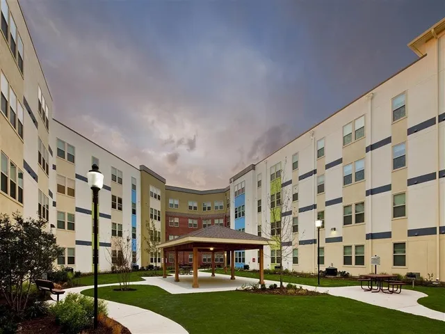 a large building with a yard in front of it