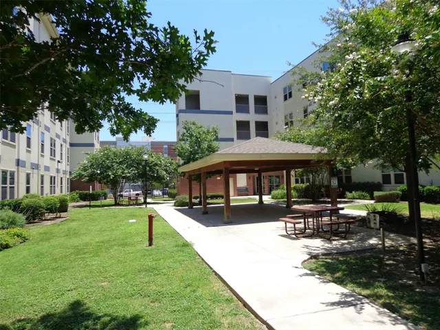 a view of a house with backyard porch and sitting area