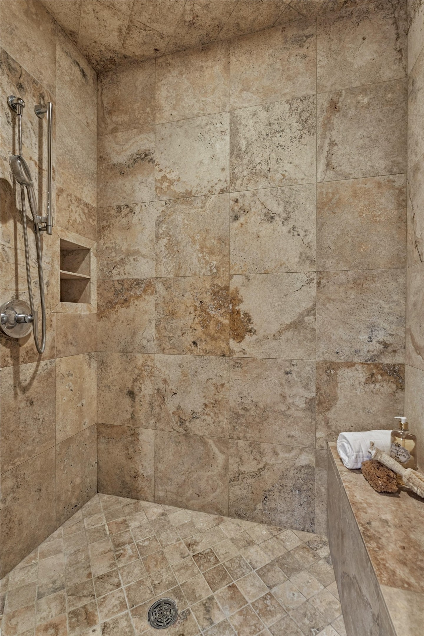 7 Dorset Square The Woodlands, TX 77381 - Photo 20 of 50 Spacious walk-in primary shower with built-in bench seating and shelving.