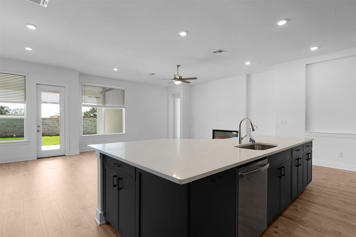 1129 Pansy Trail Georgetown, TX 78628 - Photo 12 of 28 a kitchen with a sink and a wooden floor
