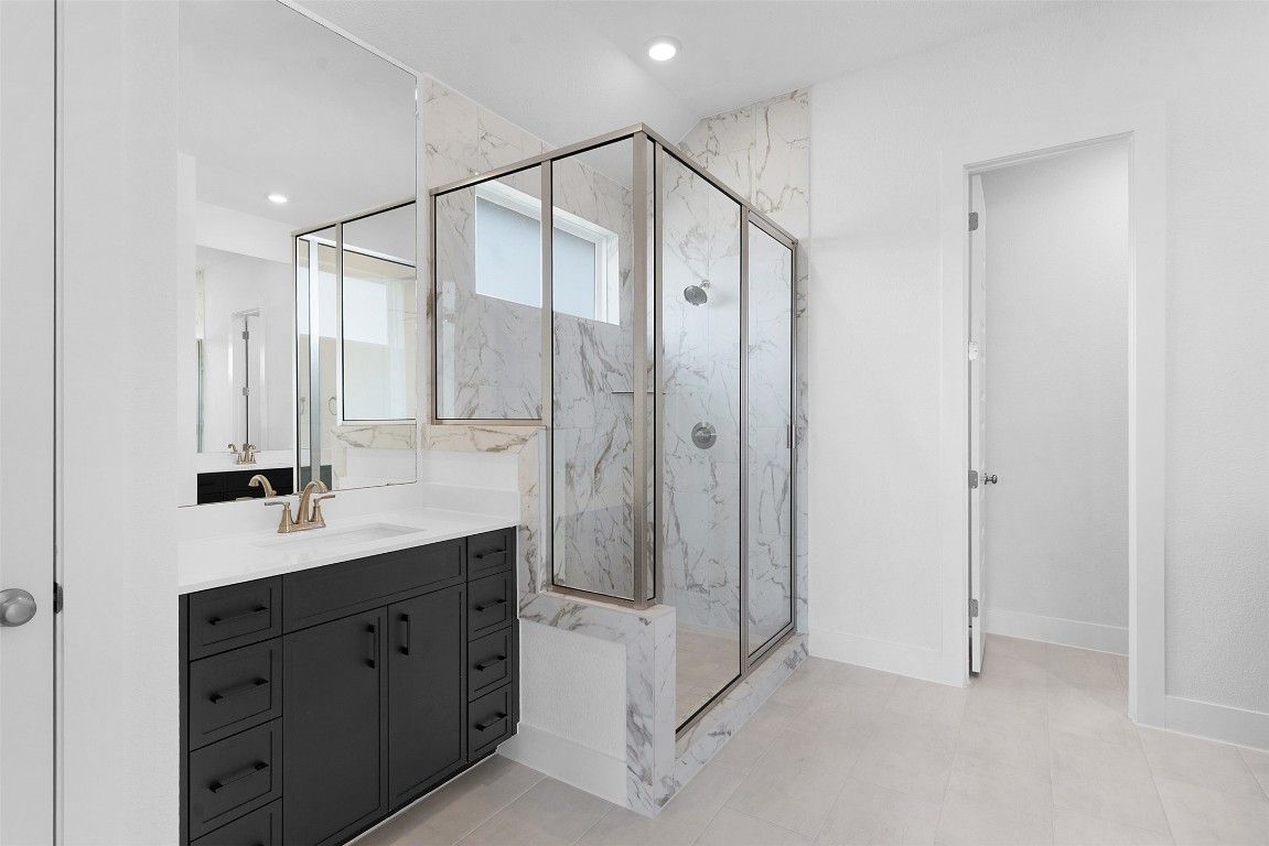 1129 Pansy Trail Georgetown, TX 78628 - Photo 16 of 28 a bathroom with a shower sink and mirror