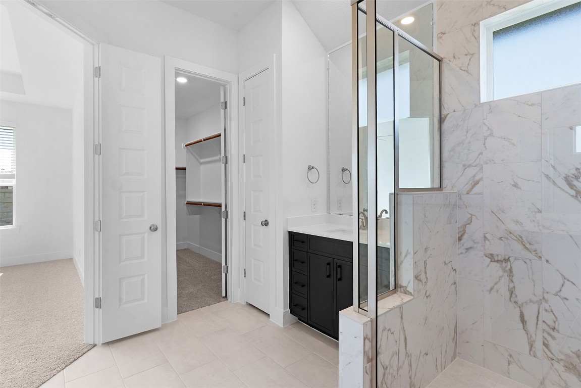 1129 Pansy Trail Georgetown, TX 78628 - Photo 18 of 28 a bathroom with a shower and a glass door