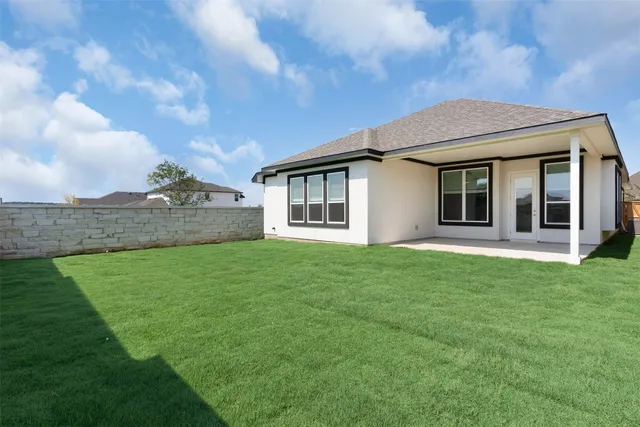 a view of a house with a backyard