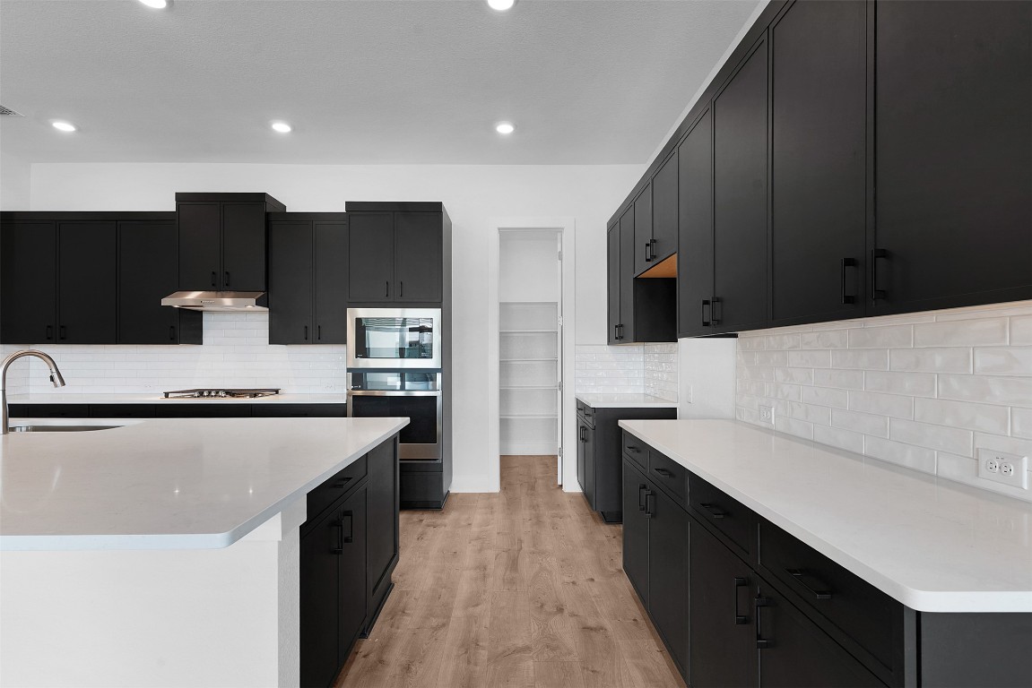 1129 Pansy Trail Georgetown, TX 78628 - Photo 9 of 28 a large kitchen with stainless steel appliances a sink dishwasher a stove and a refrigerator