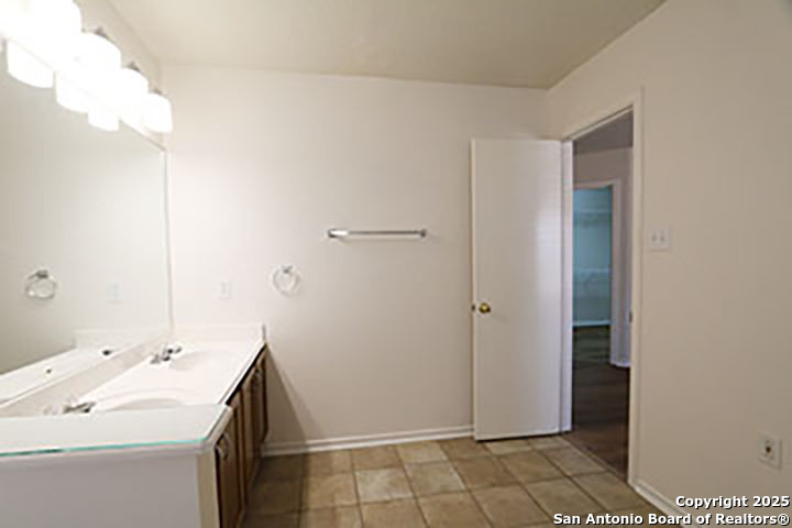 9827 Copperway Converse, TX 78109 - Photo 11 of 16 a room with a sink and a mirror