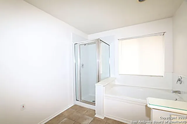 a bathroom with a bathtub and shower