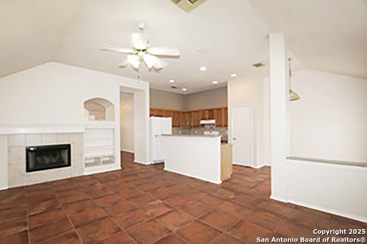 9827 Copperway Converse, TX 78109 - Photo 4 of 16 a bedroom with a bed and a fireplace