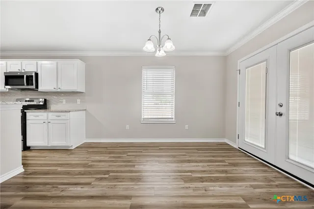 a view of kitchen with granite countertop cabinets and wooden floor