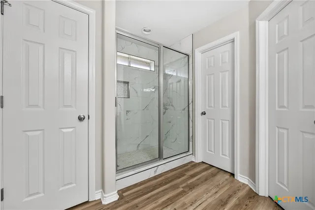 a view of a bathroom with a glass door shower