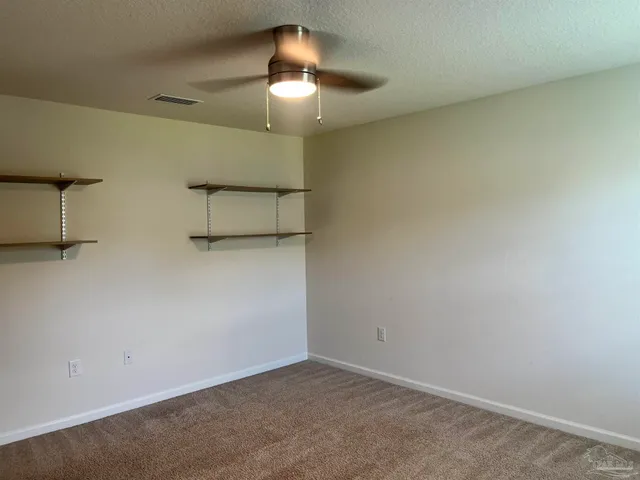 an empty room with a fan