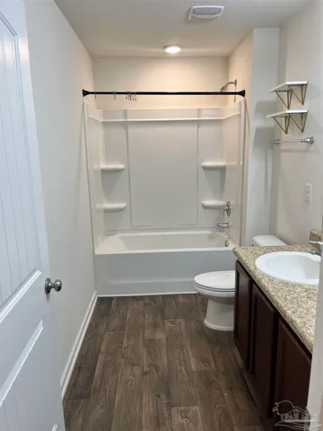 an empty room with a window and ceiling fan