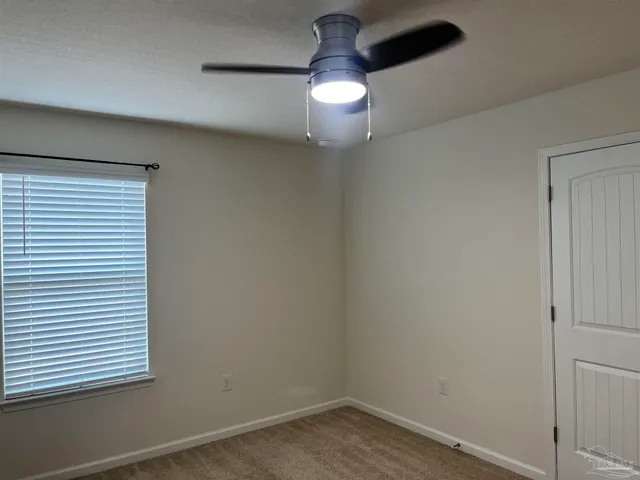 a view of a house with a yard and potted plants