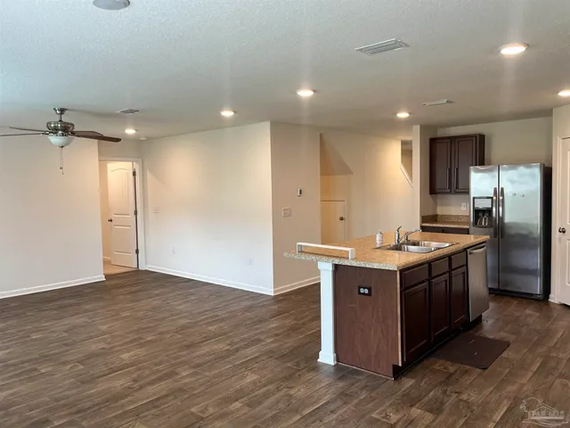 a kitchen with a sink and refrigerator
