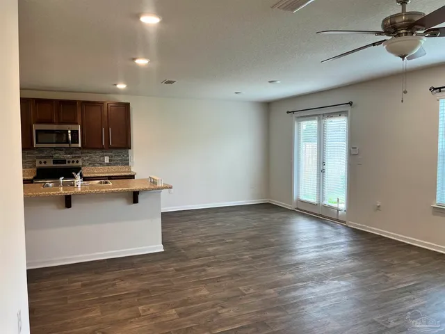 a view of kitchen with sink microwave and stove