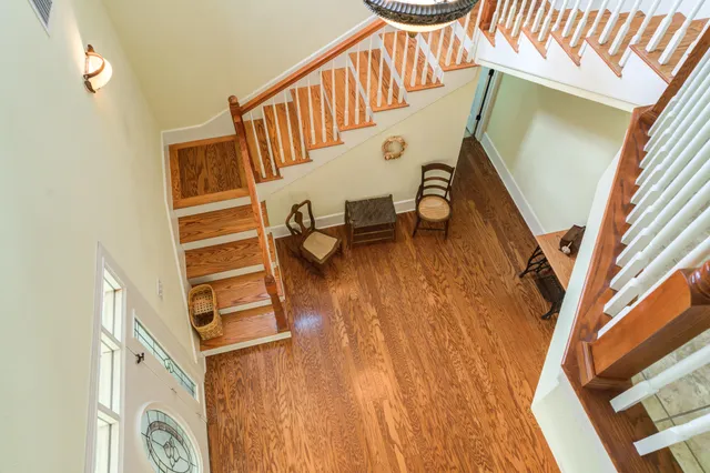 a living room with furniture a fireplace and a chandelier