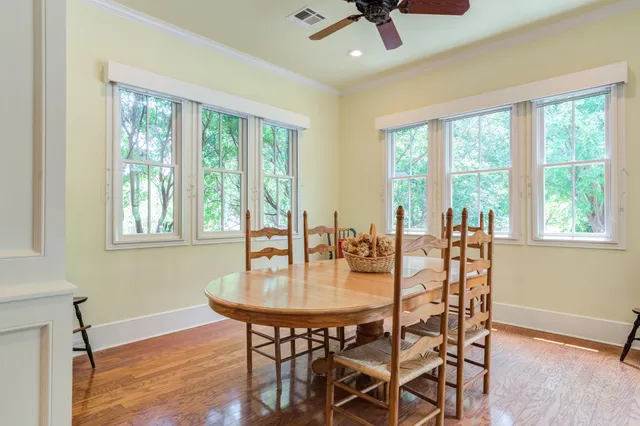 a kitchen with stainless steel appliances granite countertop a sink a stove and a wooden floors