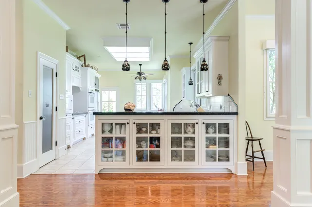 a spacious bathroom with a double vanity sink a large mirror and a shower